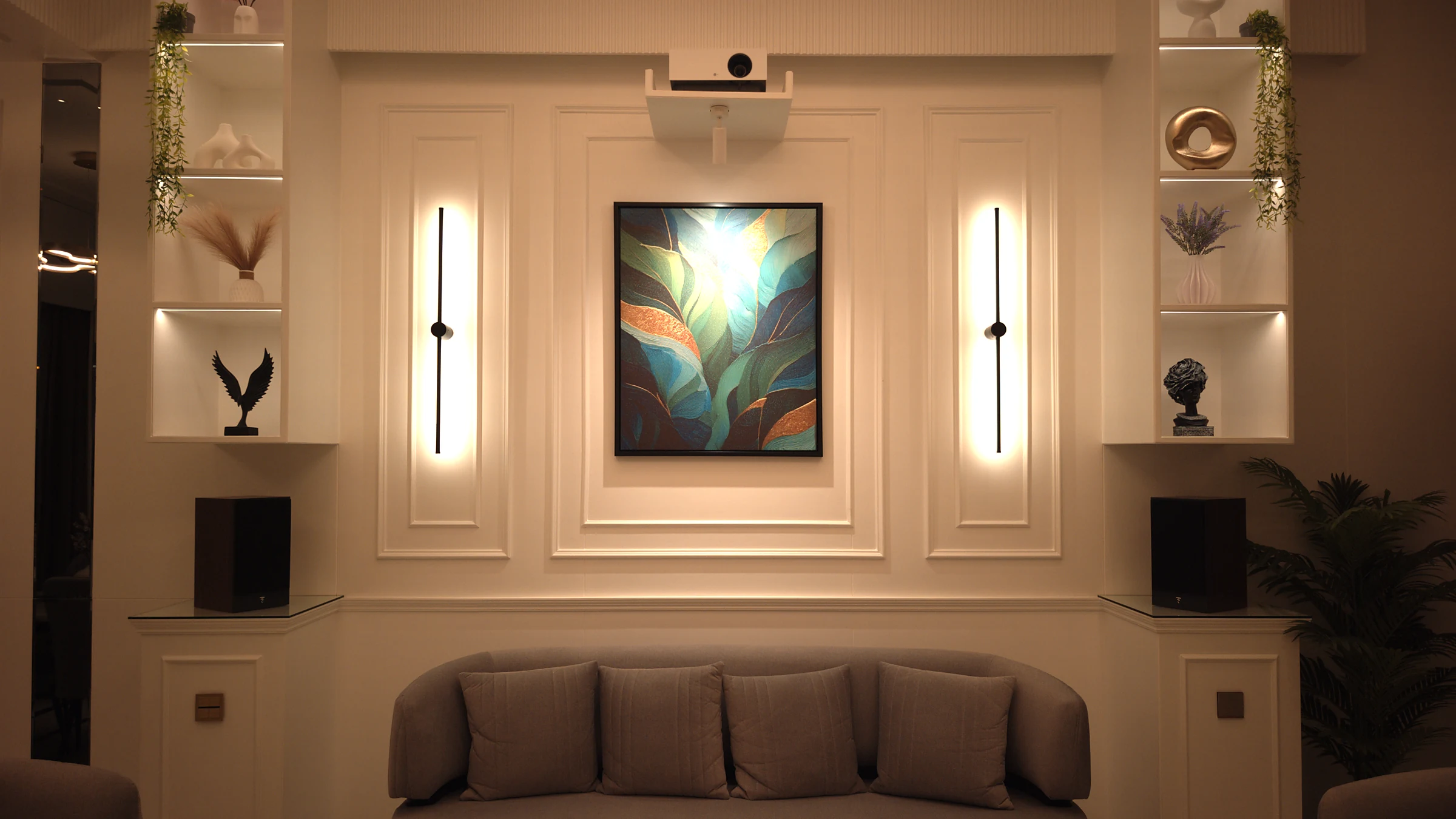 The same wall under warm afternoon light with sconces and niches lit